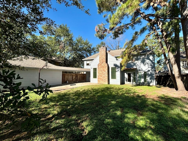 back of property with a patio and a lawn