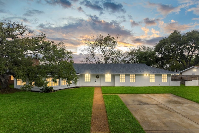 ranch-style home with a lawn