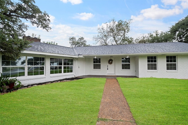 ranch-style home with a front lawn