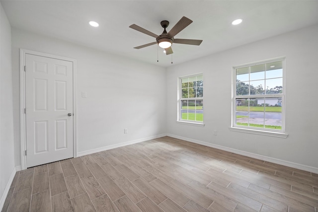 empty room featuring ceiling fan and light wood-type flooring