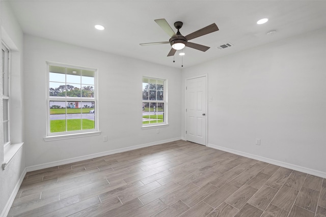 spare room with light hardwood / wood-style floors and ceiling fan