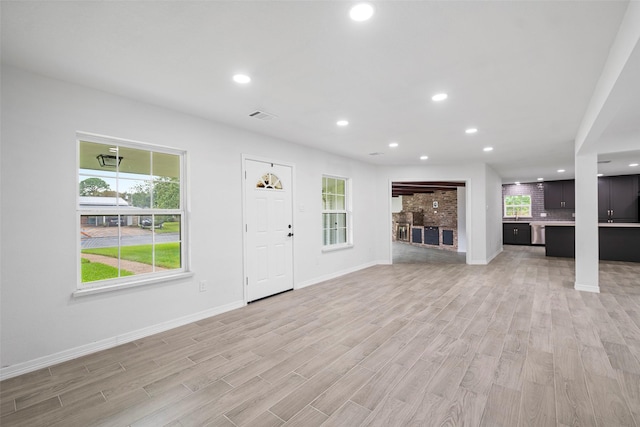 unfurnished living room with light wood-type flooring