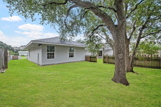 rear view of property featuring a yard