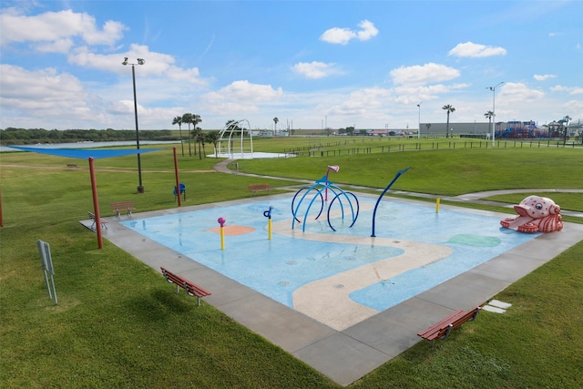 view of home's community featuring a lawn and a water view