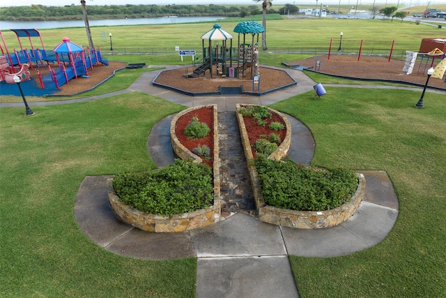 view of home's community featuring a water view and a playground