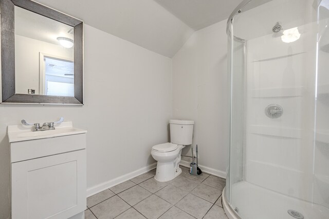 bathroom with walk in shower, tile patterned flooring, vaulted ceiling, toilet, and vanity