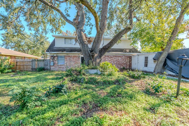 back of house with a yard