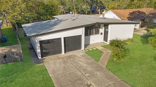 view of front facade with a garage and a front lawn