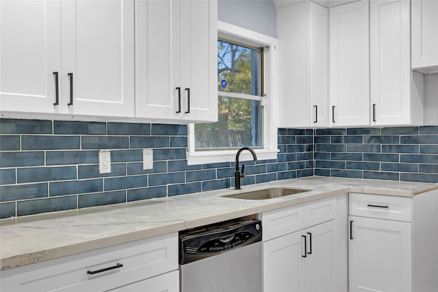 kitchen featuring white cabinetry, stainless steel dishwasher, and sink