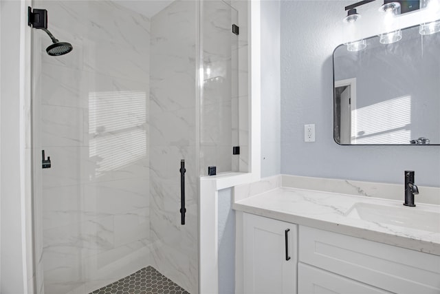 bathroom featuring vanity and a shower with shower door