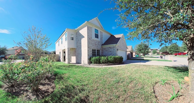 view of side of property featuring a garage and a lawn