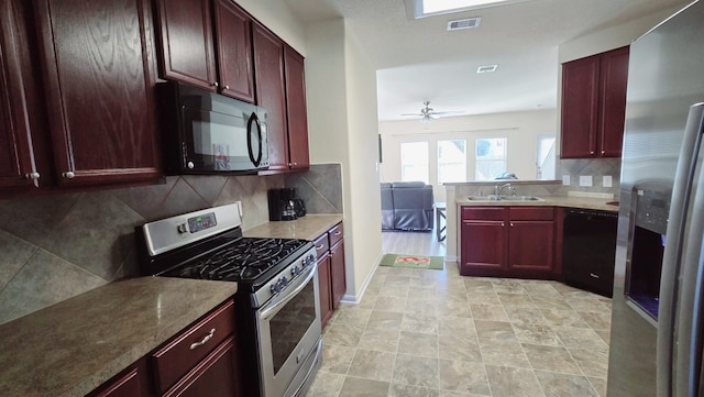 kitchen featuring ceiling fan, sink, kitchen peninsula, decorative backsplash, and black appliances