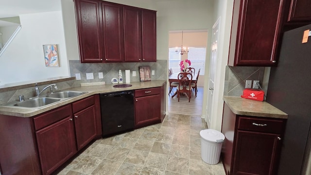 kitchen featuring dishwasher, tasteful backsplash, stainless steel fridge, a chandelier, and decorative light fixtures