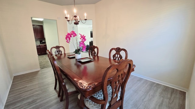 dining area with a chandelier and dark hardwood / wood-style floors