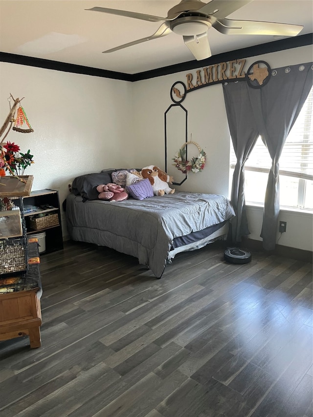 bedroom featuring ceiling fan, dark hardwood / wood-style floors, and ornamental molding