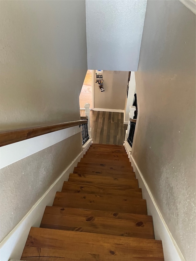 stairway with hardwood / wood-style flooring