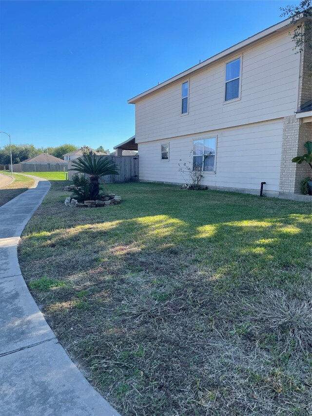 view of side of property featuring a yard