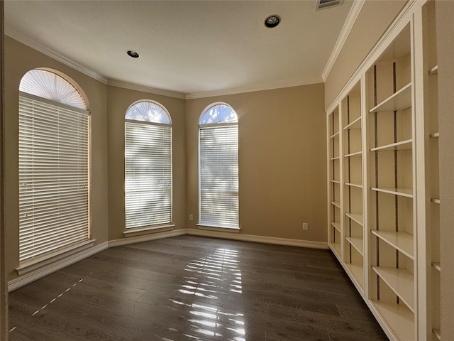 empty room featuring crown molding and dark hardwood / wood-style flooring