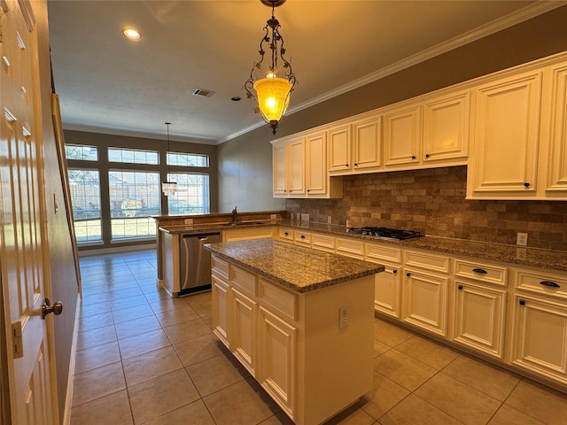 kitchen with appliances with stainless steel finishes, decorative light fixtures, a kitchen island, and light tile patterned floors