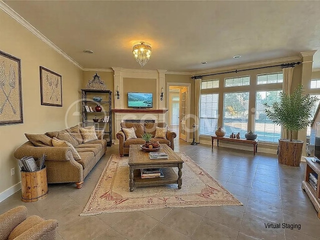 living room featuring ornamental molding, a chandelier, tile patterned floors, and a fireplace