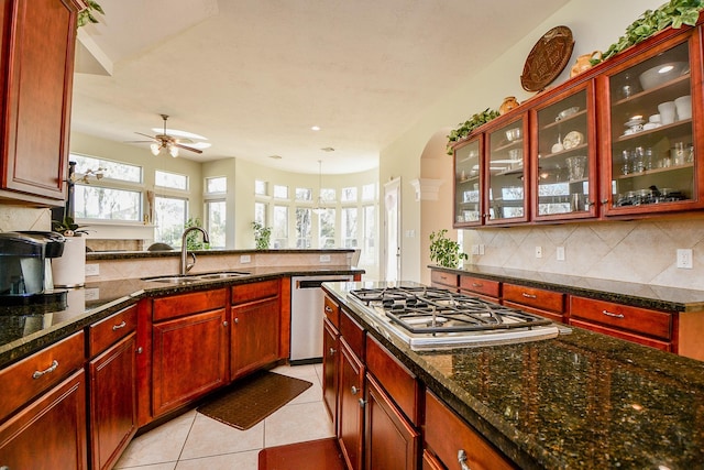 kitchen with a wealth of natural light, ceiling fan, sink, and appliances with stainless steel finishes