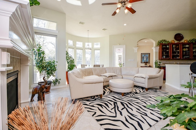 tiled living room with ceiling fan