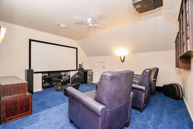 cinema with ceiling fan, lofted ceiling, and dark colored carpet