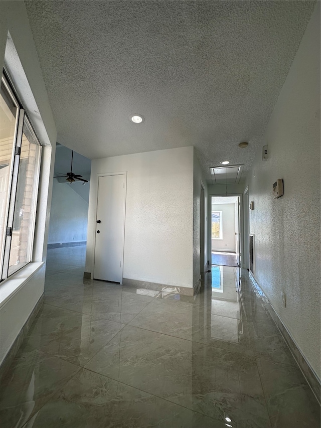 corridor featuring a textured ceiling