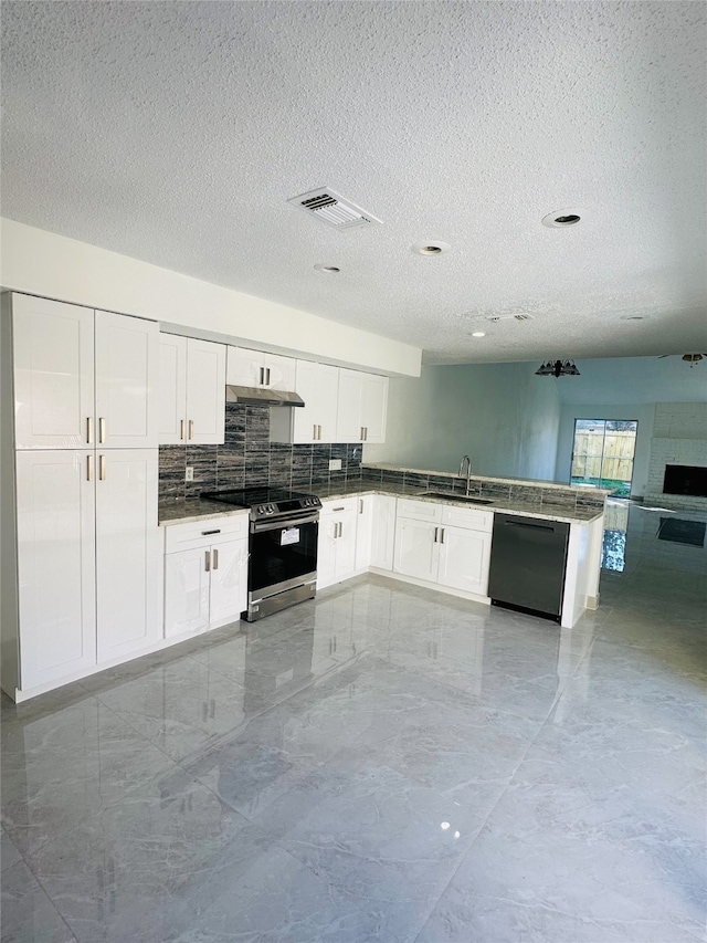 kitchen featuring dishwasher, sink, stainless steel stove, a textured ceiling, and white cabinetry