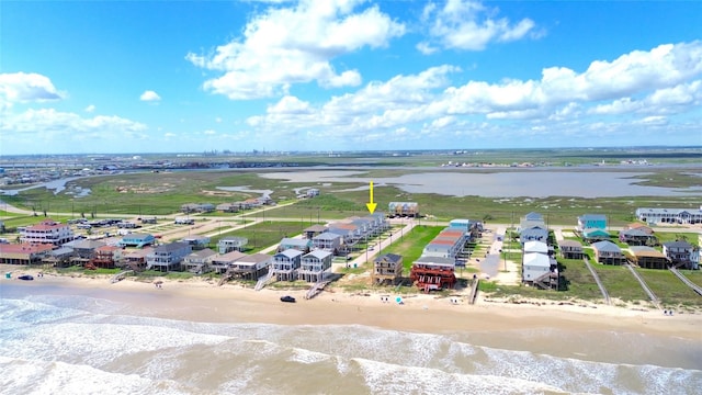 drone / aerial view featuring a water view and a beach view