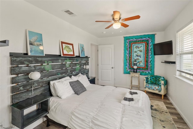 bedroom with ceiling fan and hardwood / wood-style flooring