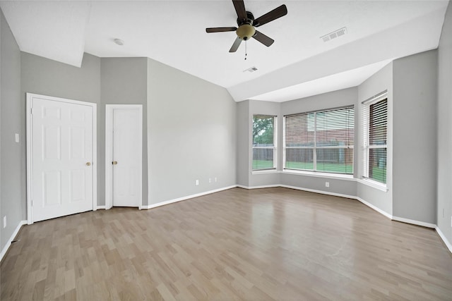 spare room with ceiling fan, light hardwood / wood-style flooring, and lofted ceiling