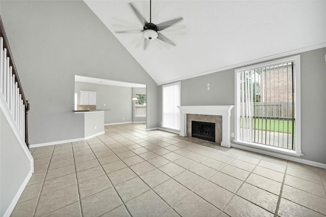 unfurnished living room featuring ceiling fan, light tile patterned floors, high vaulted ceiling, and a tiled fireplace