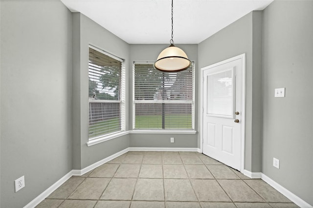 unfurnished dining area with light tile patterned floors