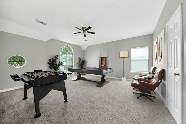 playroom with light carpet, ceiling fan, and a healthy amount of sunlight