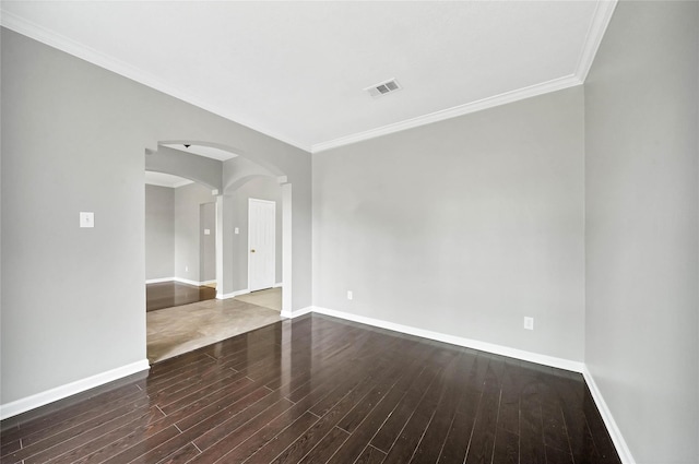 spare room featuring crown molding and dark hardwood / wood-style flooring