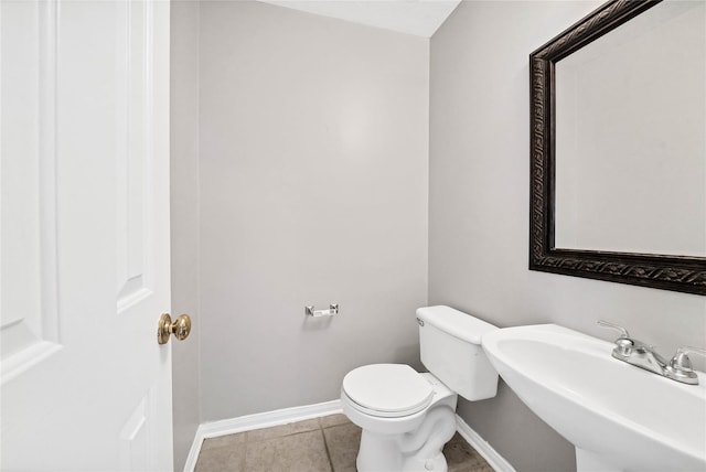 bathroom with tile patterned flooring, toilet, and sink