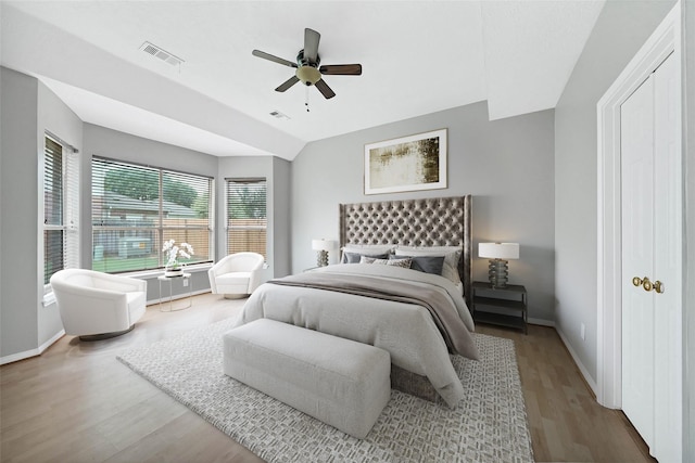 bedroom featuring hardwood / wood-style floors, ceiling fan, and lofted ceiling