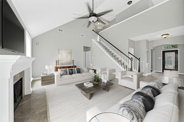 living room with ceiling fan and high vaulted ceiling