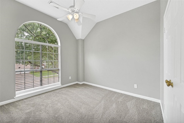 empty room with ceiling fan, carpet, and lofted ceiling