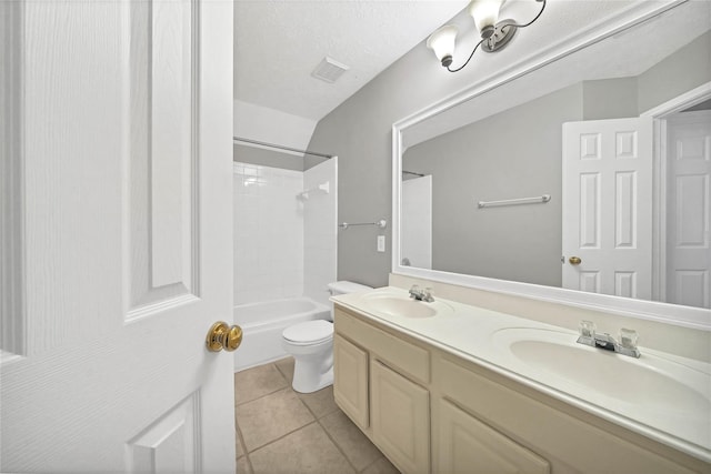 full bathroom with vanity, tile patterned floors, toilet, a textured ceiling, and shower / bathtub combination