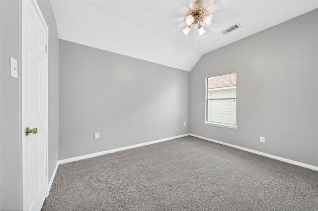 unfurnished room featuring carpet, vaulted ceiling, and ceiling fan