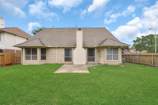 back of property featuring a yard and a patio