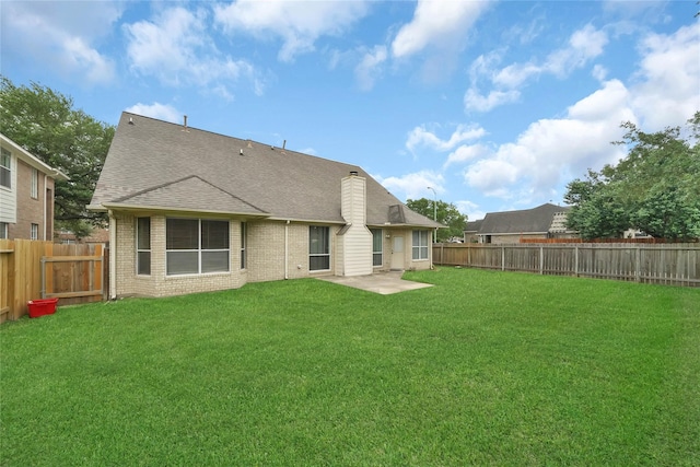 back of house featuring a yard and a patio