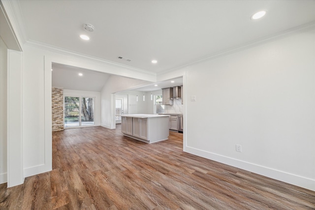 unfurnished living room featuring hardwood / wood-style floors, lofted ceiling, and crown molding