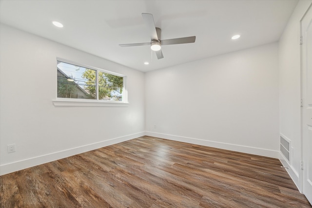 unfurnished room featuring ceiling fan and dark hardwood / wood-style floors