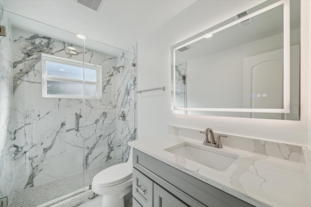 bathroom featuring vanity, toilet, and walk in shower