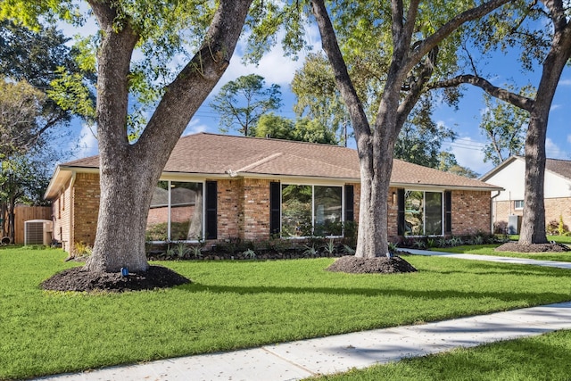 single story home featuring a front yard and cooling unit