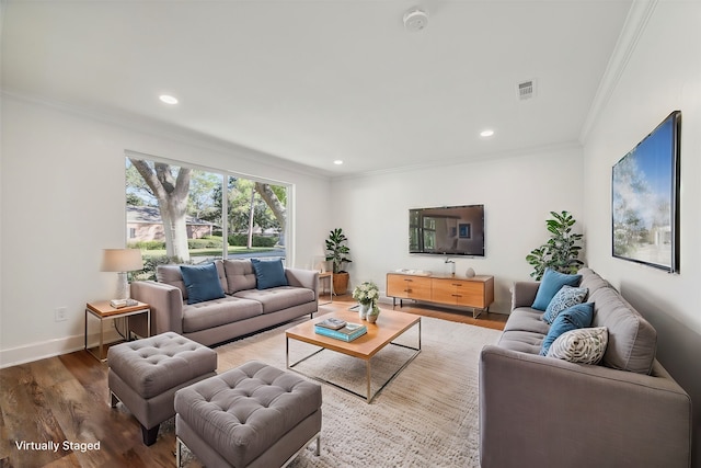 living room featuring hardwood / wood-style flooring and crown molding