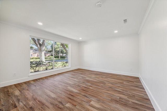 unfurnished room with wood-type flooring and crown molding